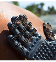 Close-up view of a black HandsOn Grooming Glove with chestnut horse hair in the scrubbers to show the de-shedding capabilities