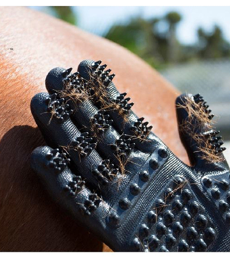 Close-up view of a black HandsOn Grooming Glove with chestnut horse hair in the scrubbers to show the de-shedding capabilities