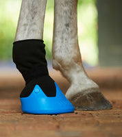 Close-up side view of a gray horse wearing the blue large Tubbease Hoof Sock