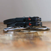 Front view of the Spicy Pepper Mane Jane Spur Straps on wood