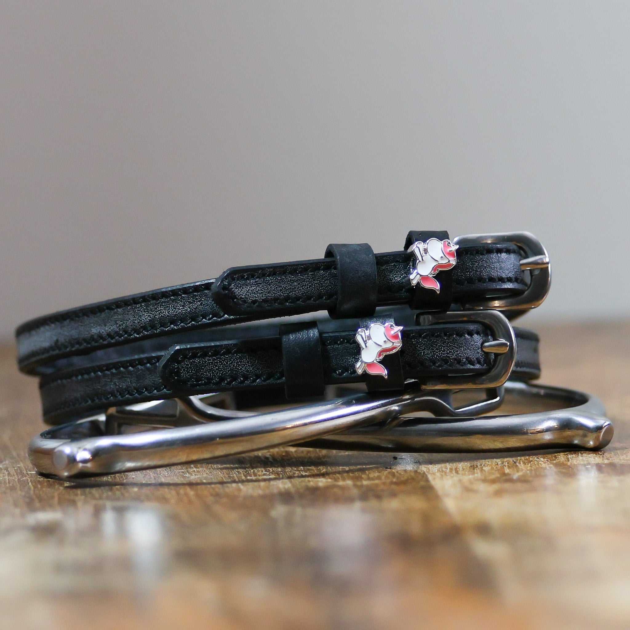 View of the Phat Unicorn Mane Jane Spur Straps on a wooden surface