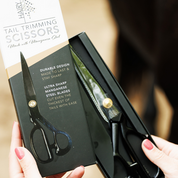 View of someone holding the Hairy Pony Horse Tail Trimming Scissors in original packaging
