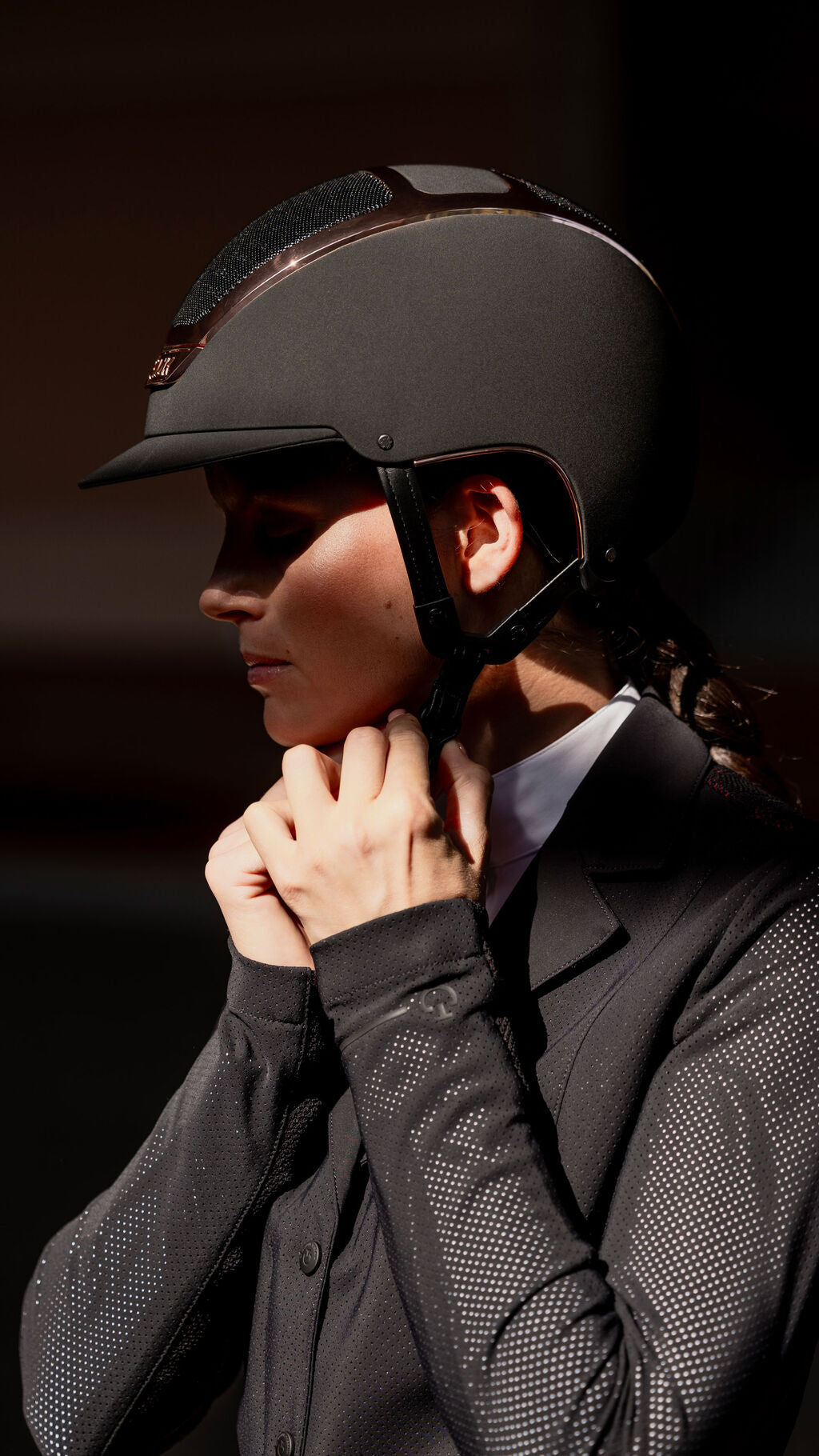 Side view of a female model wearing the black everyrose Kask Dogma Chrome Helmet