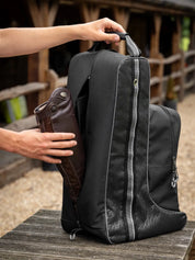Person placing boots into LeMieux Elite Pro Boot and Hat Bag in black