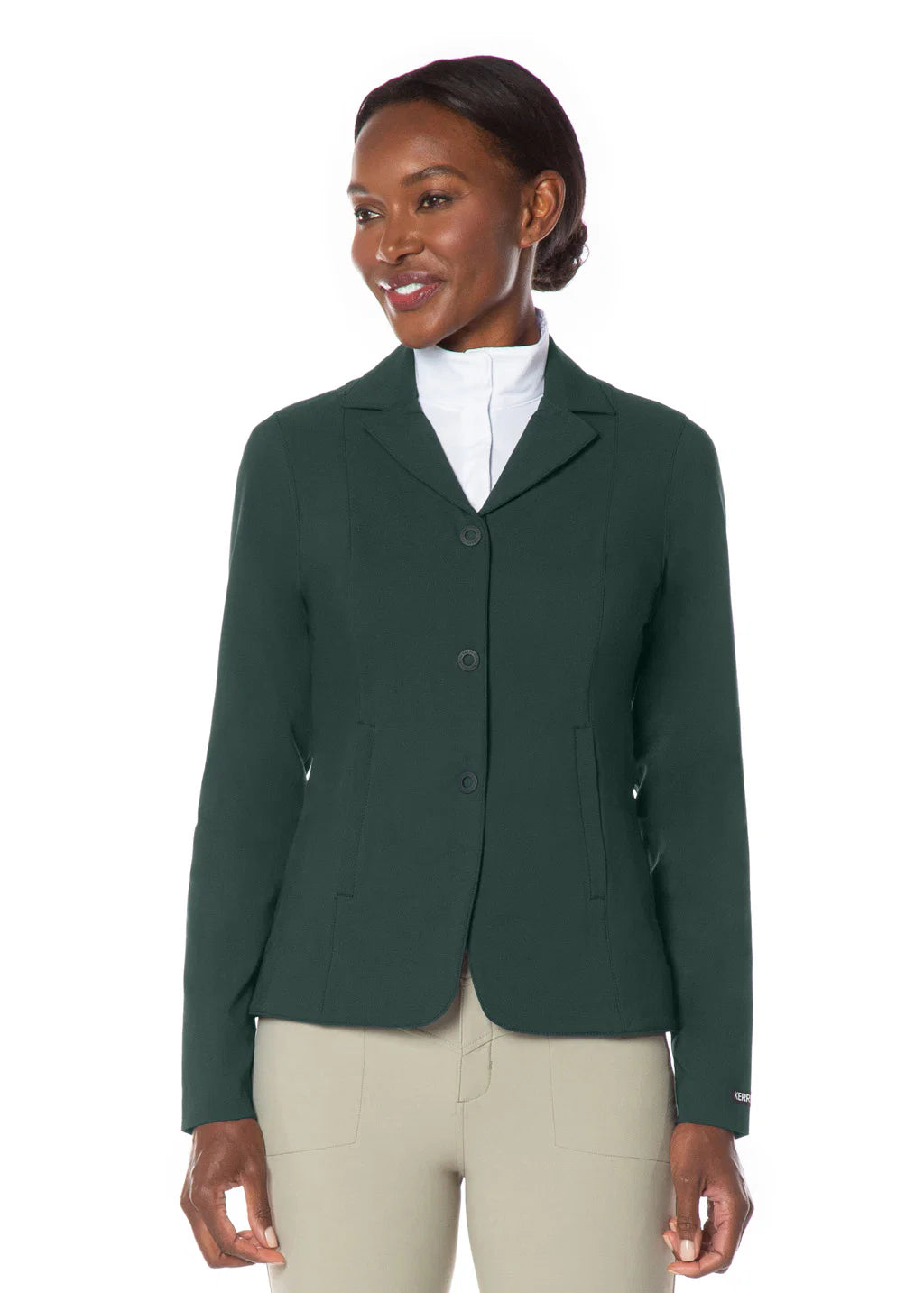 Front view of a female model wearing the green Kerrits Stretch Competitor Koat 3 Snap on a white background