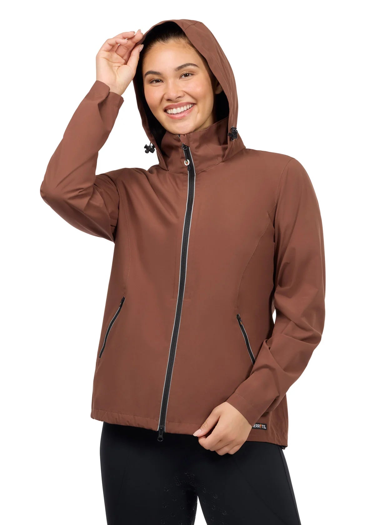 Woman wearing a brown waterproof jacket with hood up