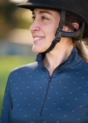 Close-up view of a female model wearing the Nightfall Lucky Dots Kerrits In the Zone Coolcore Long Sleeve Riding Shirt