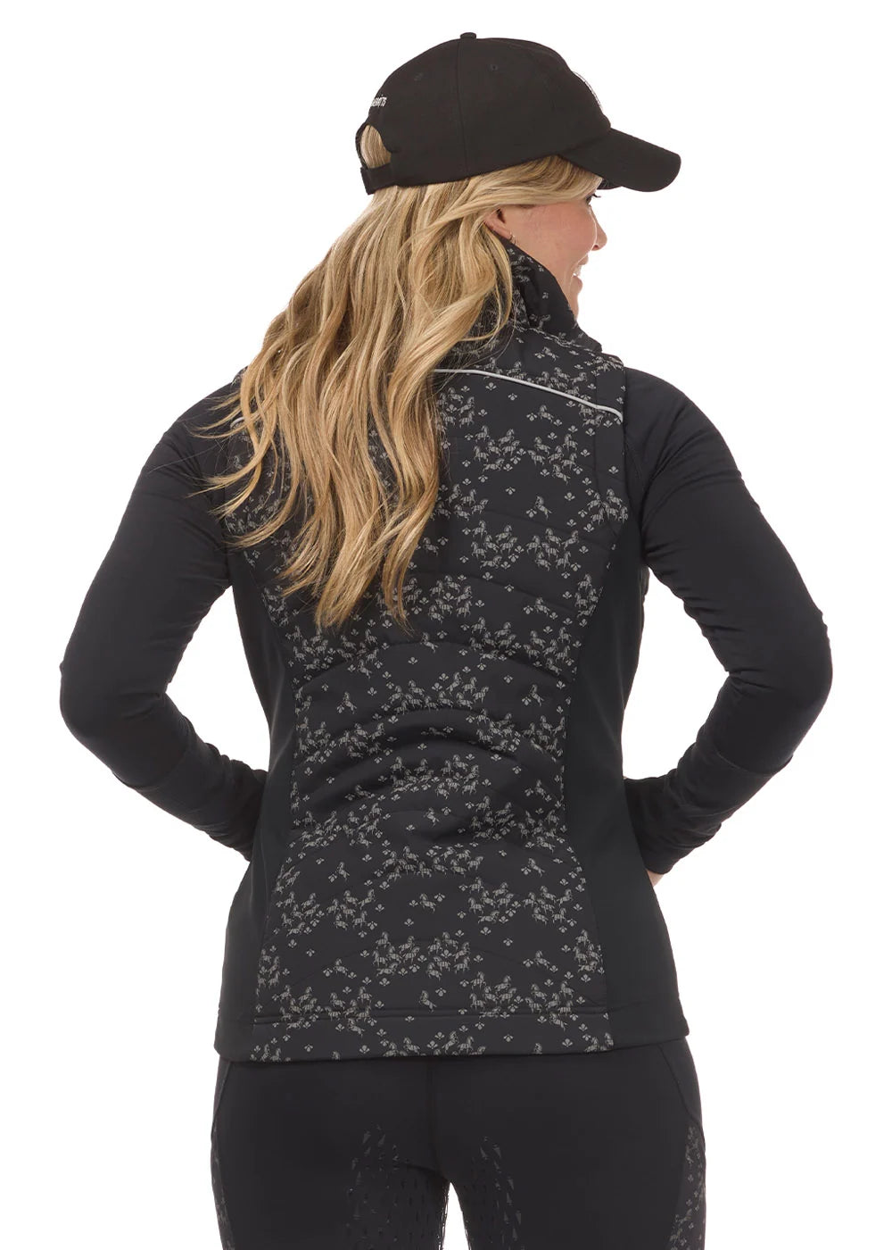 Back view of a model wearing the Black Happy Herds Kerrits Horse Reflection Quilted Vest on a white background