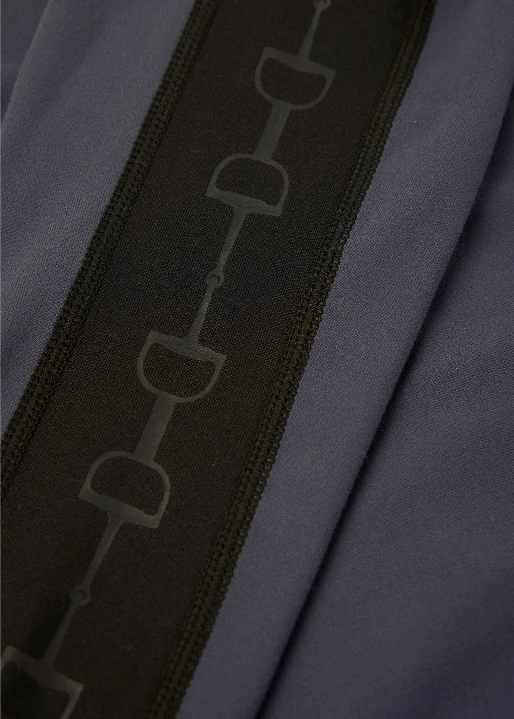 Close-up view of the bit pattern on the sleeve of the Carbon Kerrits Bit of Base Layer Top