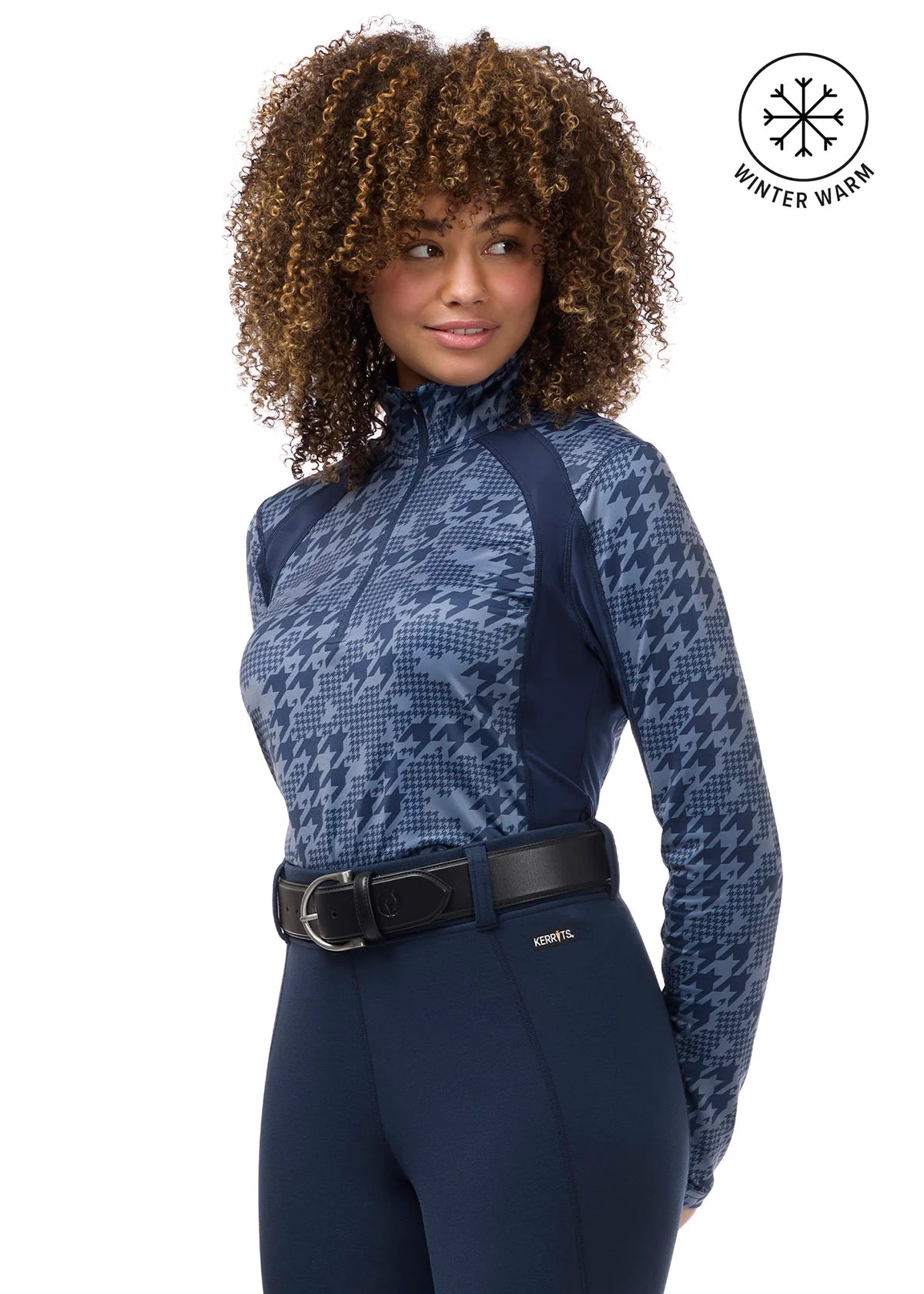Front view of a female model wearing the Dusty Blue Kerrits Traverse Quarter Zip Fleece Tech Top on a plain background