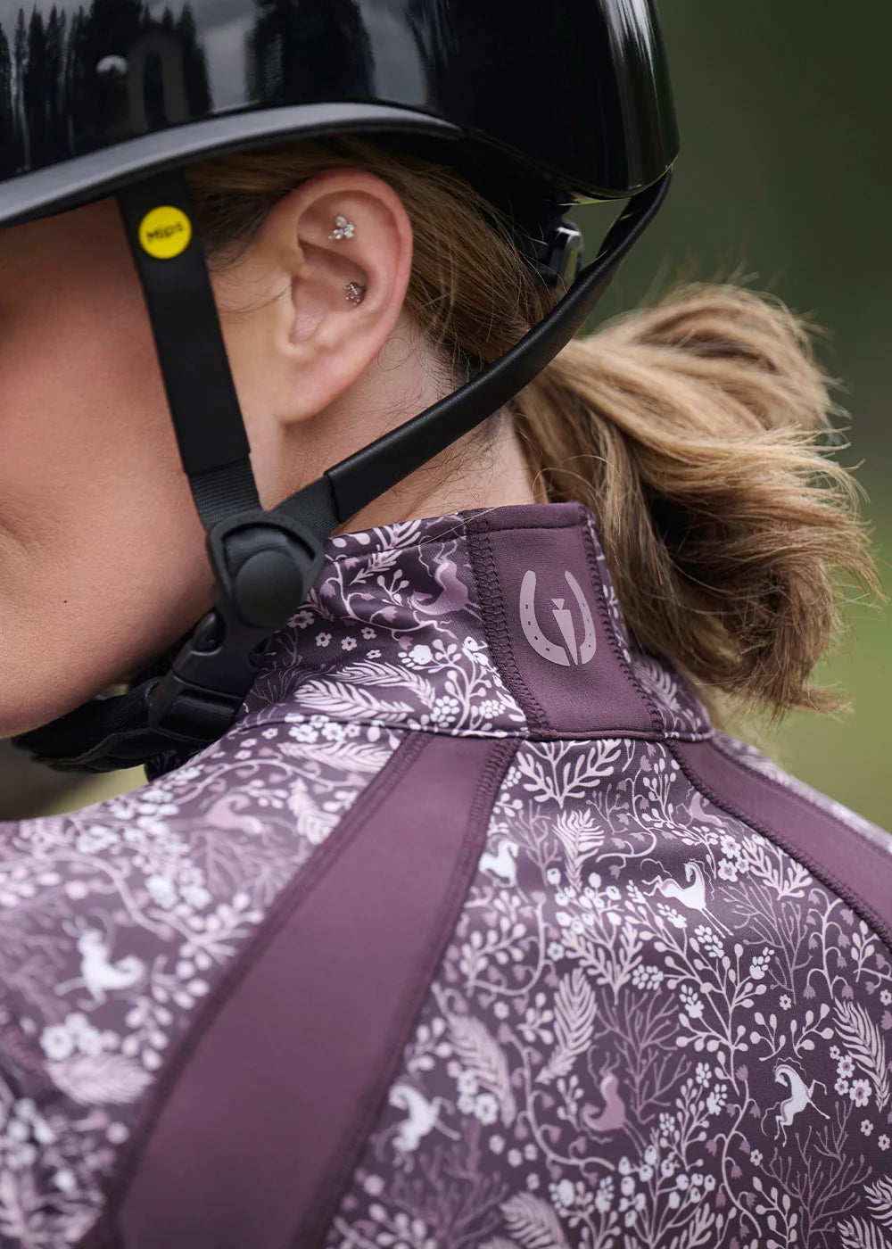 Close-up back view of a female model wearing the Elderberry Fantasy Fillies Kerrits Traverse Quarter Zip Fleece Tech Top