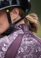 Close-up back view of a female model wearing the Elderberry Fantasy Fillies Kerrits Traverse Quarter Zip Fleece Tech Top