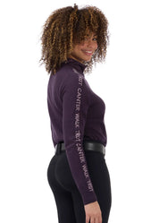 Side view of a female model wearing the Elderberry/Sugarplum Kerrits Equi Rhythm Crew Neck Sweater on a plain background