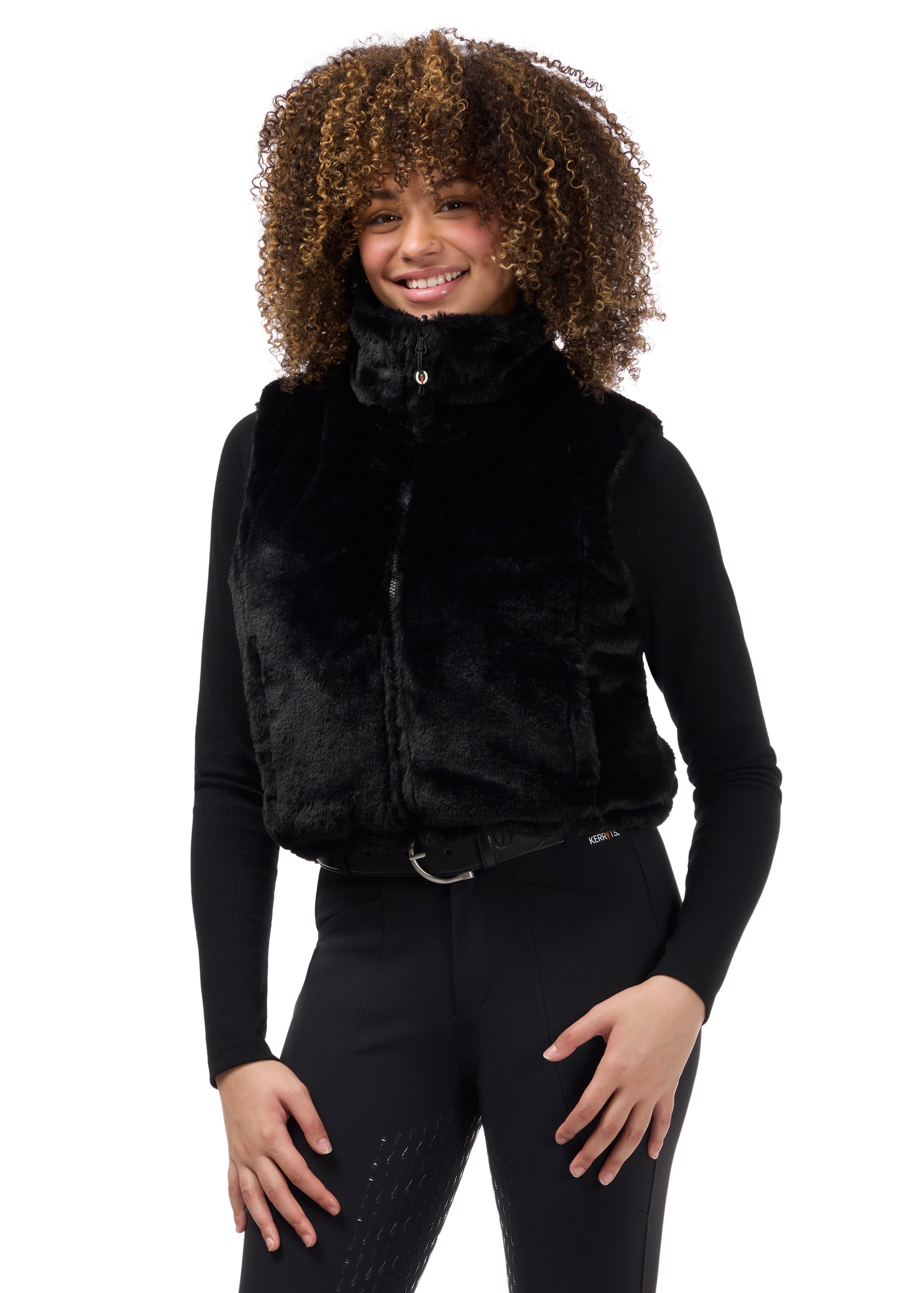 Front view of a model wearing Black Kerrits Skyline Houndstooth Reversible Vest showing the reversible side on a white background