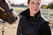 Angled front closeup view of a model wearing Black Kerrits Skyline Houndstooth Reversible Vest