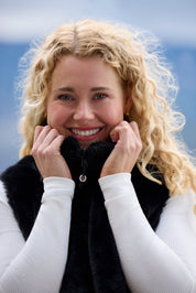 Front view of a model wearing Black Kerrits Skyline Houndstooth Reversible Vest showing the reversible side