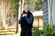 Front view of a model wearing Nightfall Kerrits Skyline Houndstooth Reversible Vest showing the reversible side