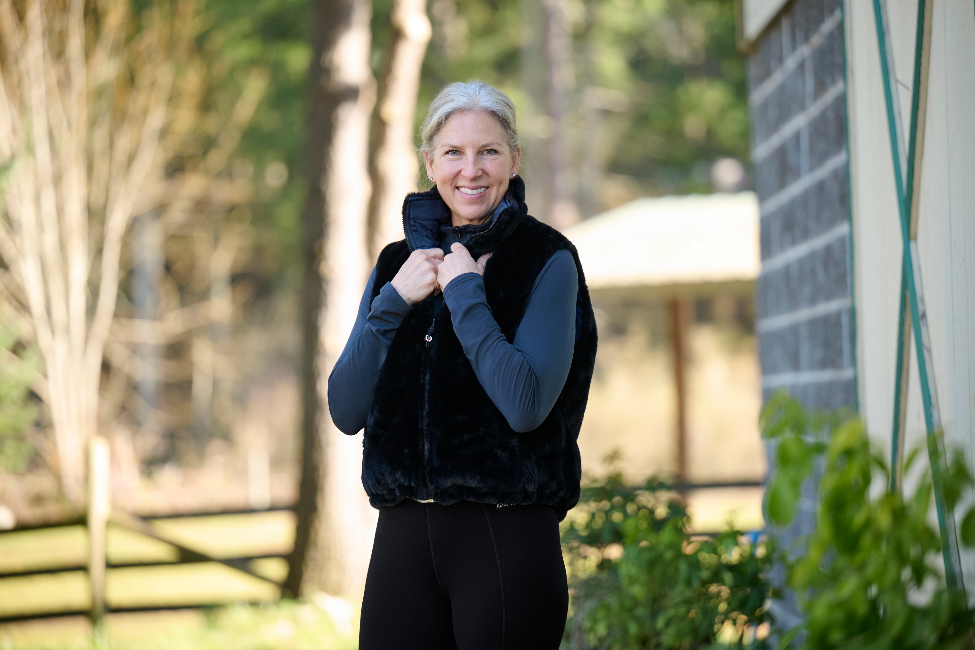 Front view of a model wearing Nightfall Kerrits Skyline Houndstooth Reversible Vest showing the reversible side