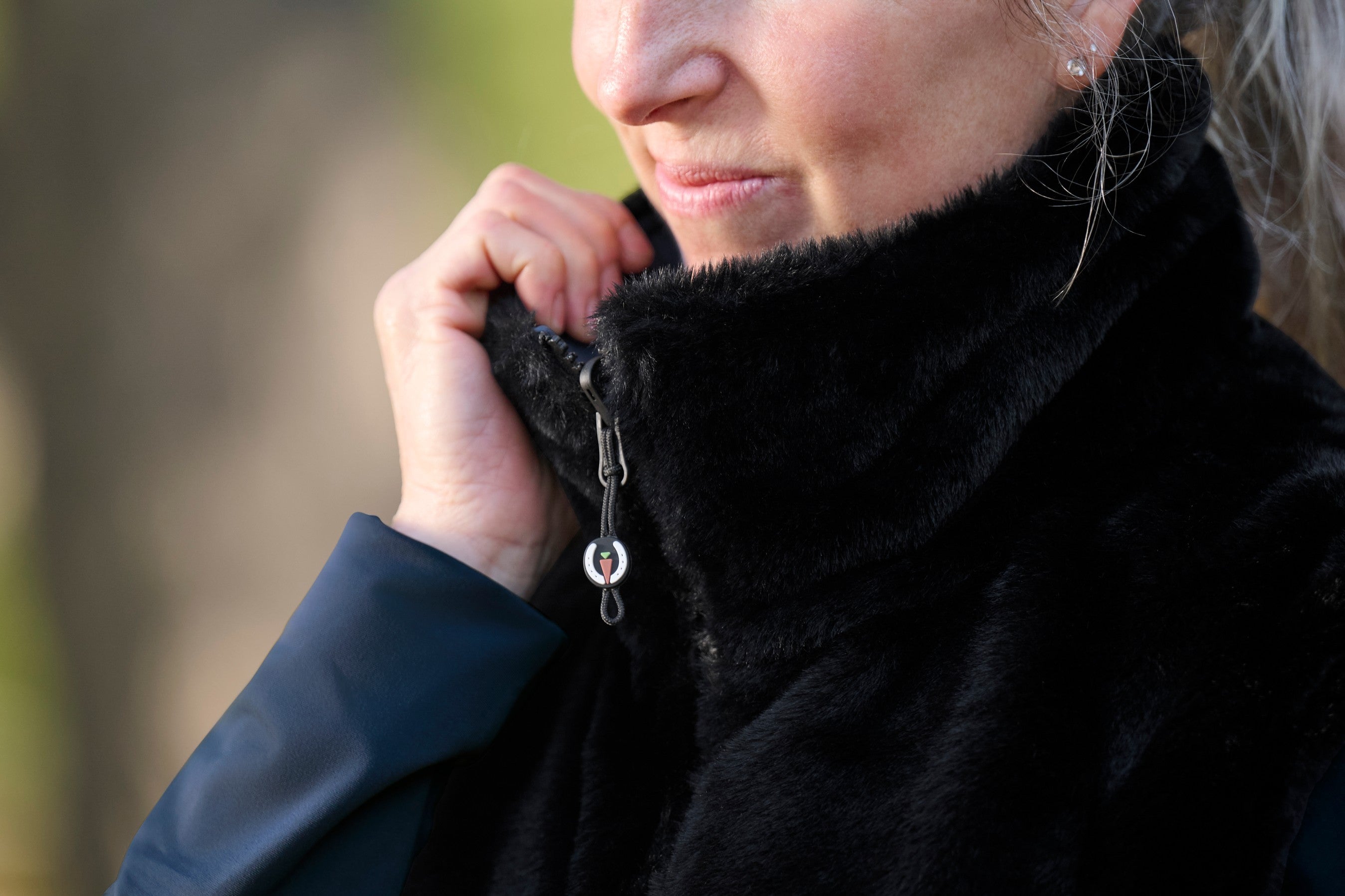 Front closeup view of a model wearing Nightfall Kerrits Skyline Houndstooth Reversible Vest showing the reversible side