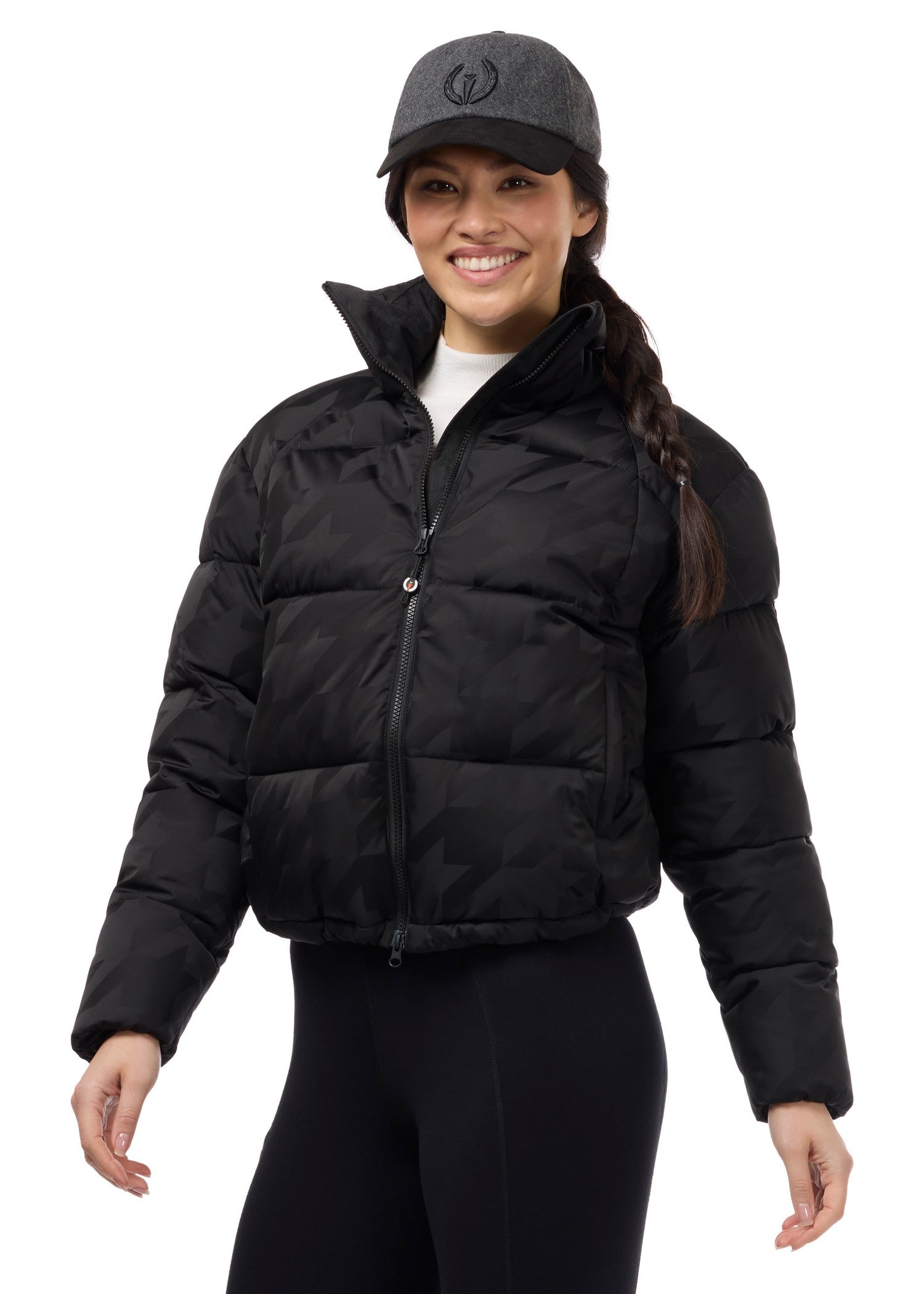 Front view of a model wearing Black Kerrits Skyline Houndstooth Puffer Jacket on a white background