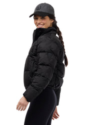 Side view of Black Kerrits Skyline Houndstooth Puffer Jacket on a white background