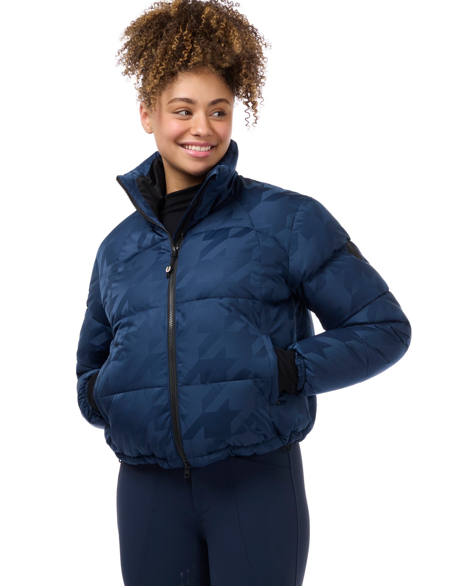 Front view of a model wearing Nightfall Kerrits Skyline Houndstooth Puffer Jacket