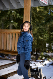 Side view of a model wearing Nightfall Kerrits Skyline Houndstooth Puffer Jacket