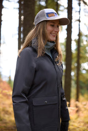 Side view of a model wearing Carbon Kerrits Weatherlock Three-Quarter Length Jacket