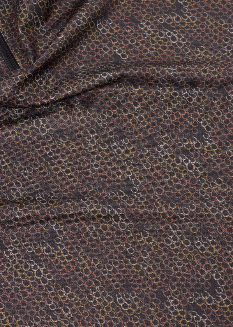 Close-up of brown patterned fabric on sleeveless riding shirt