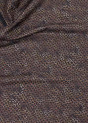 Close-up of brown patterned fabric on sleeveless riding shirt