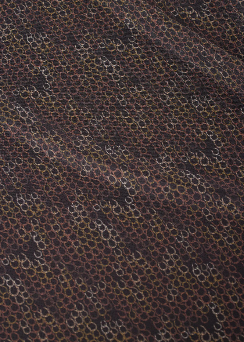 Close-up of brown patterned fabric on riding shirt