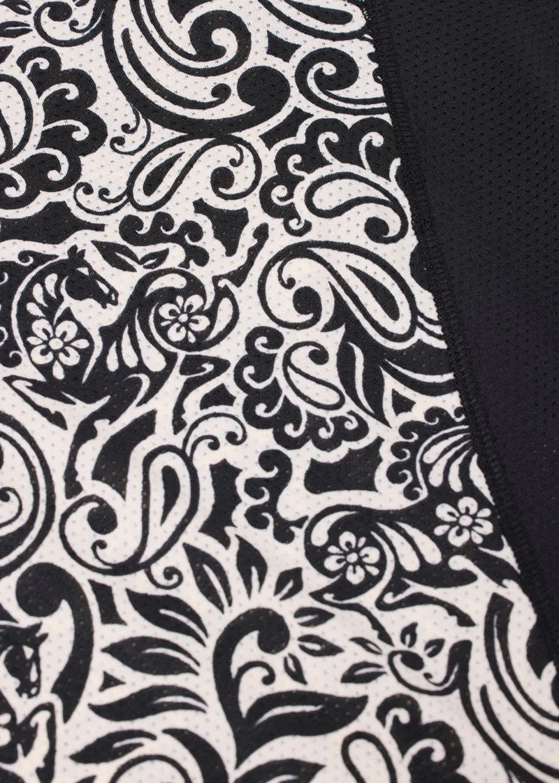 Close-up of black and white patterned fabric on riding shirt