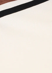 Close-up of sleeve showing striped detail on the shirt