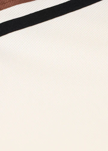 Close-up of sleeve showing striped detail on the shirt