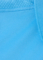Close-up of bright blue fabric texture on the polo shirt