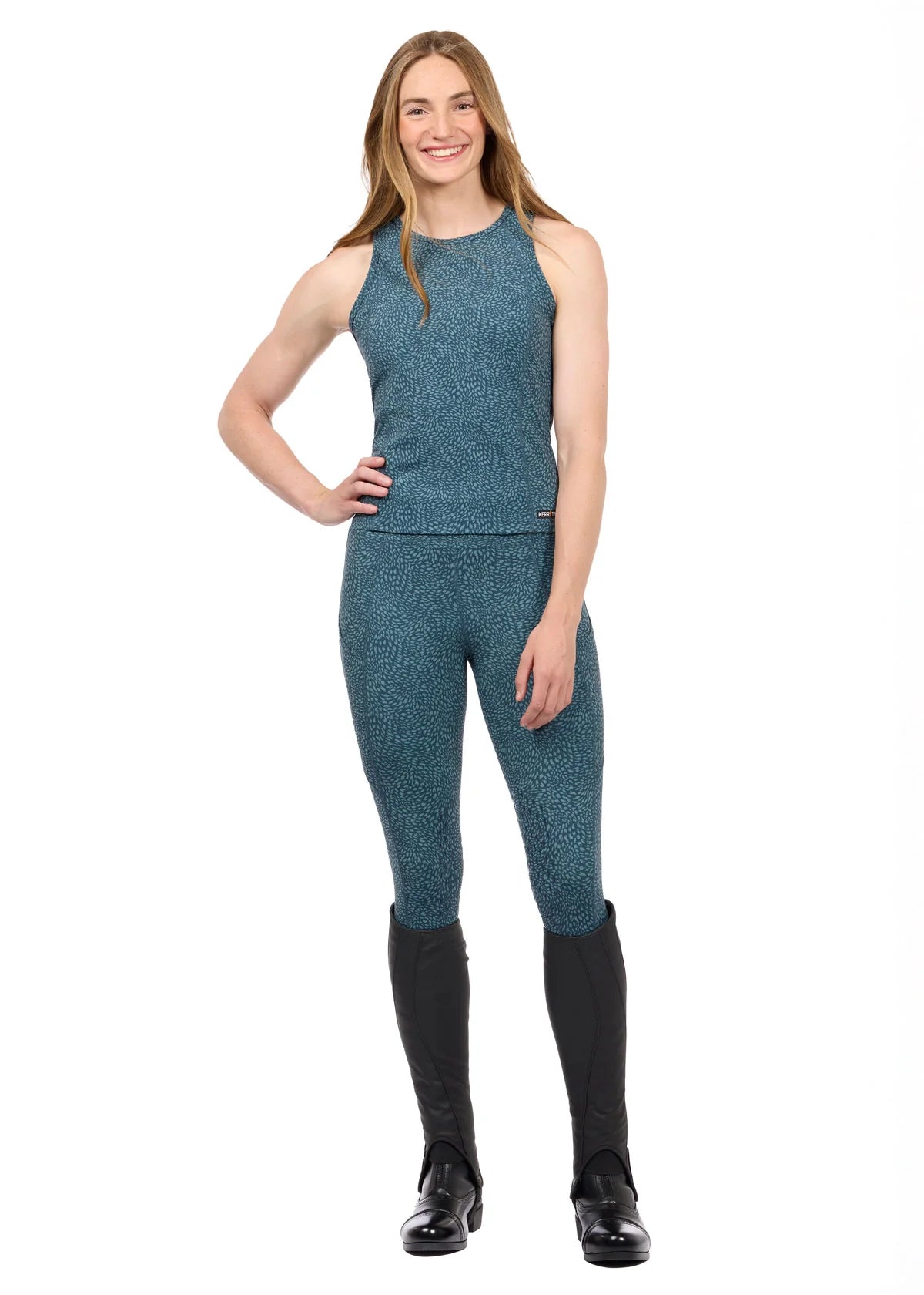 Woman wearing Kerrits Printed Sport Tank in Jasper blue, full body view on white background