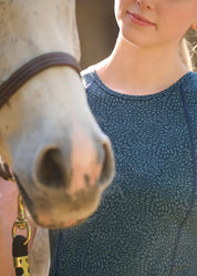 Close-up of Kerrits Printed Sport Tank in Jasper blue fabric with horse muzzle