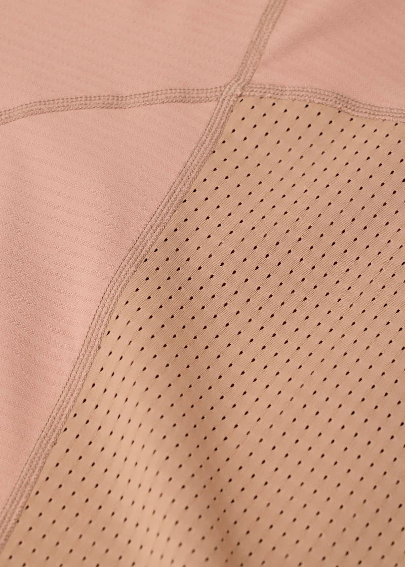 Close-up of perforated fabric on tan riding top