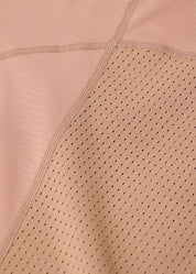 Close-up of perforated fabric on tan riding top