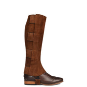 Side view of the brown Ovation EZE Tab Suede Half Chaps over a brown boot on a white background