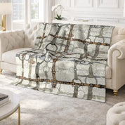 View of the All Designs Equine Ivory Bit Plaid Equestrian Crushed Velvet Throw on a white couch