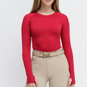 Front view of a female model wearing the Sour Cherry TKEQ Kennedy Seamless Long Sleeve Shirt 2.0 on a white background