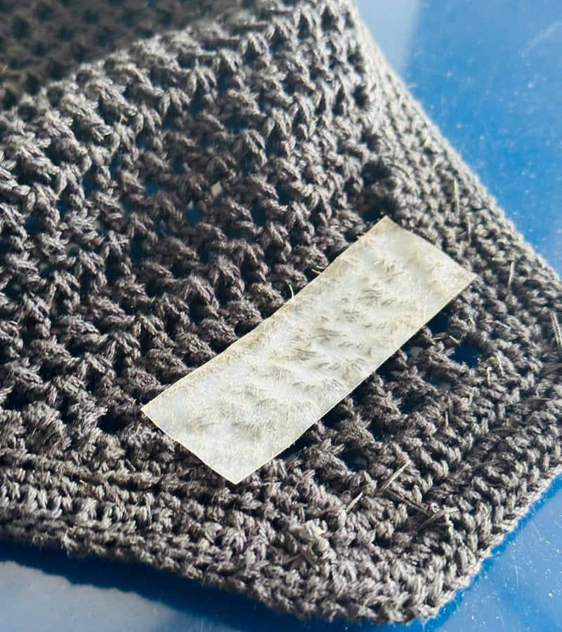 An AJ Equestrian Bonnet Bond Securing Strip on the underside of a brown ear bonnet