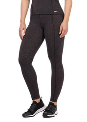 Woman wearing brown printed riding tights with athletic shoes, front view