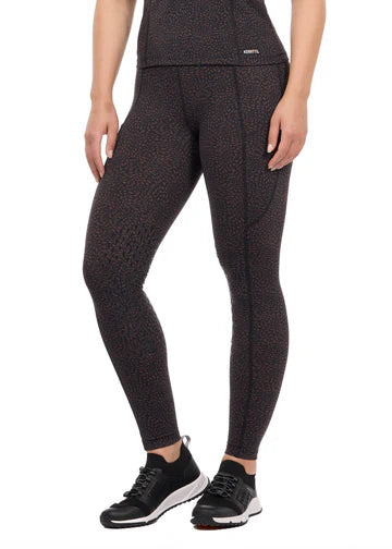Woman wearing brown printed riding tights with athletic shoes, front view
