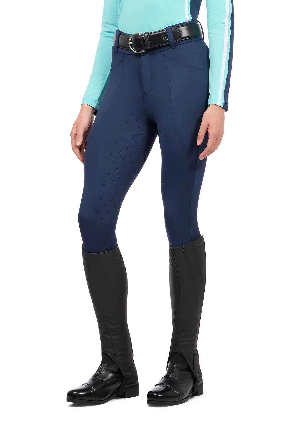 Front view of a model wearing the blue Kerrits Free Motion Coolcore Full Seat Breech on a white background