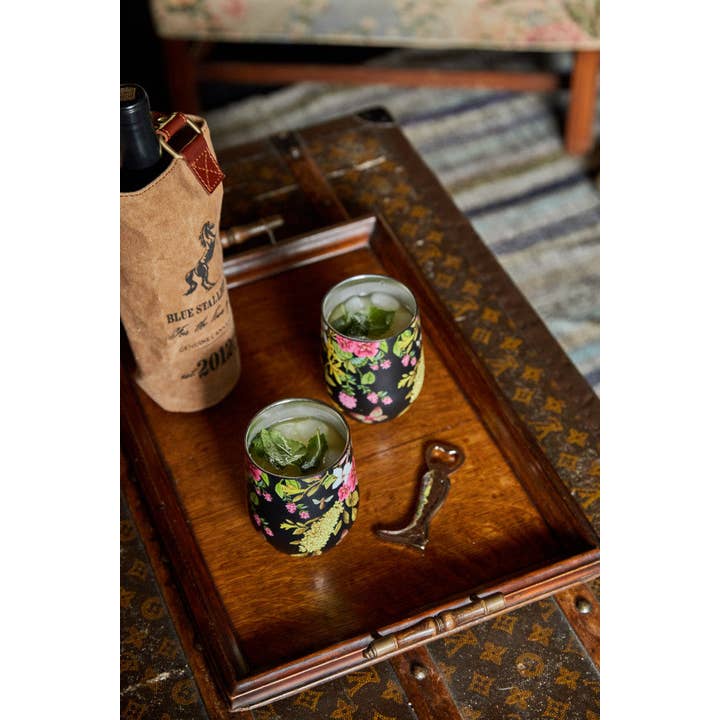 View of the riding boot Blue Stallion Farm Zinc Bottle Opener on a wooden tray with drinkware