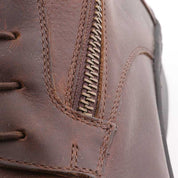 Close-up view of the zipper on a brown Kavalkade Romulus Oiled Leather Side Zip Paddock Boot
