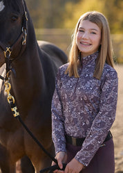 Angled front view of a model wearing Elderberry Fantasy Fillies Kerrits Kids Traverse Quarter Zip Fleece Tech Top