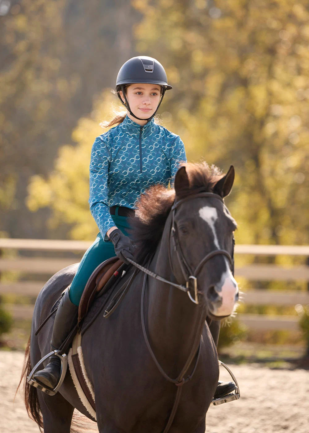 Front view of a model wearing Jasper Horseshoe Honeycomb Kerrits Kids Traverse Quarter Zip Fleece Tech Top